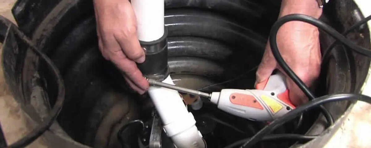 Sump pump installation technician connecting PVC discharge piping in Cape Coral, FL